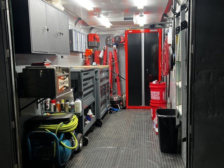 Inside the mobile shop trailer — tool chests, compressor and parts storage